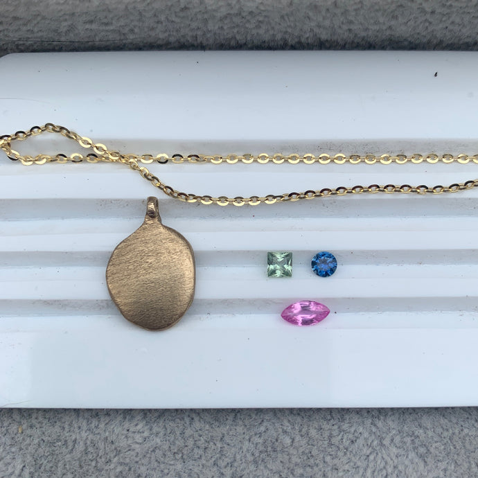 Fraser Hamilton Jewellery | Mask Pendant. Bespoke Jewellery. Pink gemstones. Sapphires. Coloured Gemstones. Bespoke Jewelry.